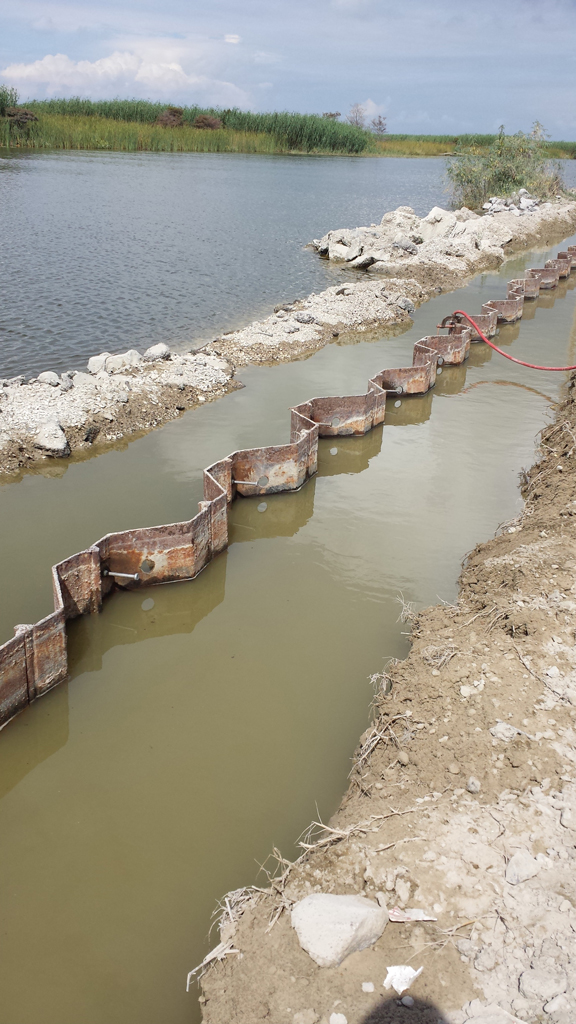 Progress of retaining wall construction along the road stretch with sheet pile installation